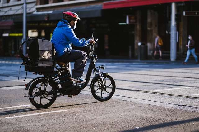 Delivery driver riding electric bike