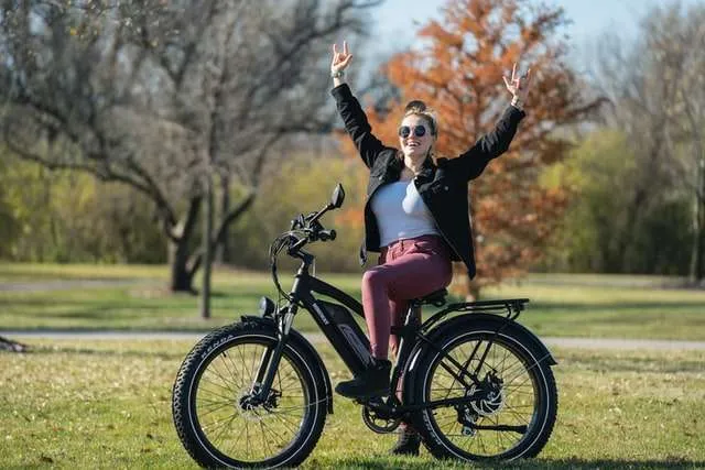 Happy woman on black electric bike