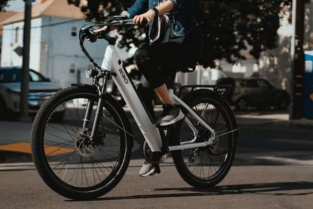 Woman commuting on white electric bike