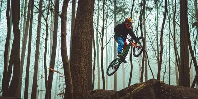 Mountain biker in the air over trail