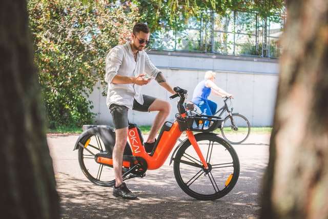 Man on Orange Okai electric bike