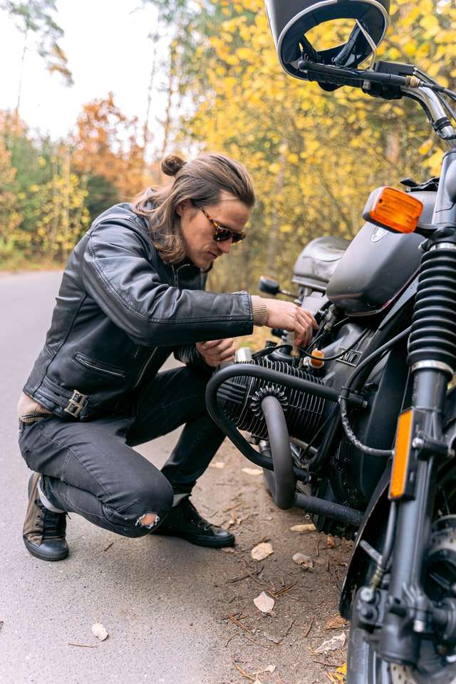 Biker repairing his motorbike