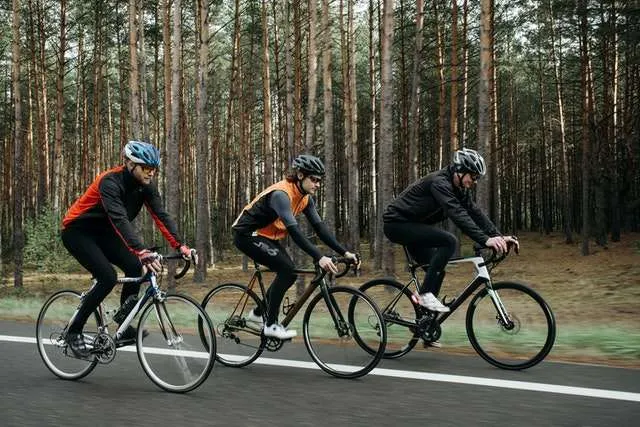 3 men road biking together