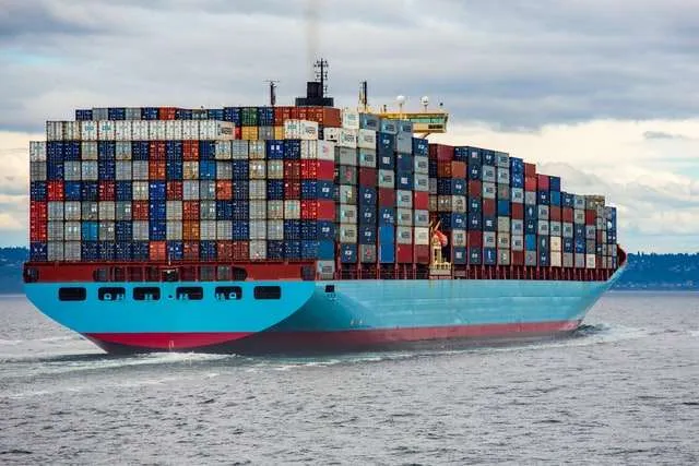 Shipping vessel on the move showing shipping containers