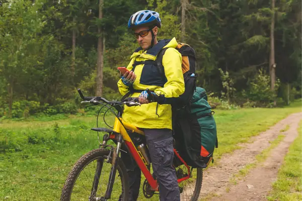 bikepacker on bike with his camping gear