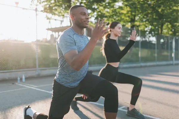 man and woman exercising in the park