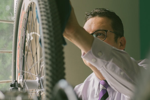 man cleaning his bicycle tires