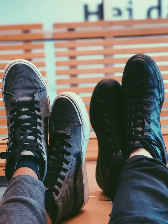 two crosslegged feet wearing vans shoes
