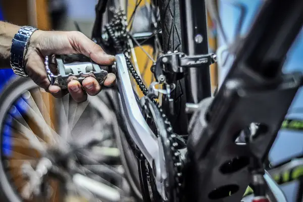 bike mechanic testing out bike pedals