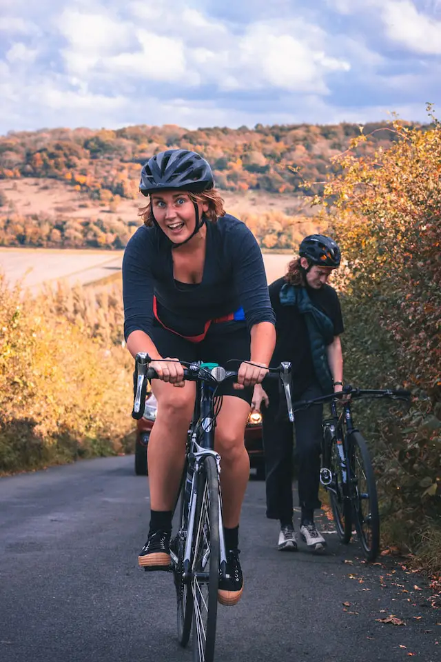 female cyclist climbing uphill