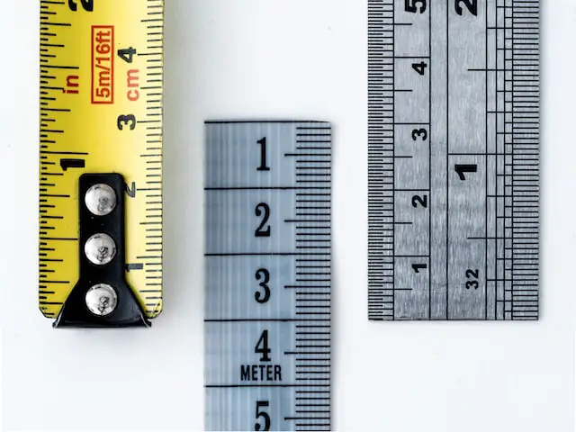 Two metal rulers and a tape measure
