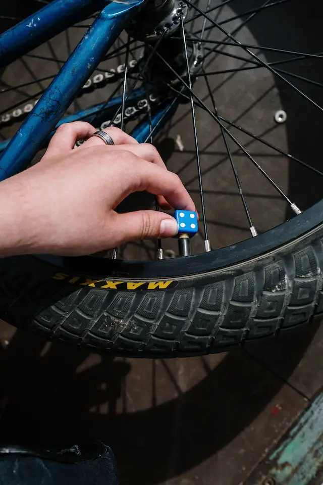 cyclist reducing bike tire pressure