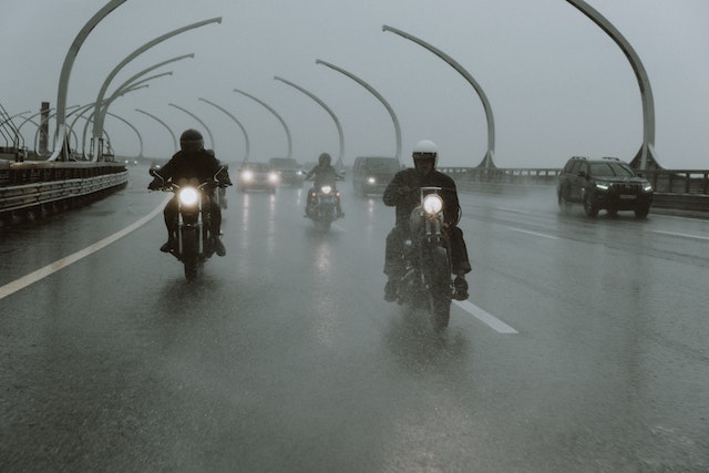 three bikers riding on highway in the rain