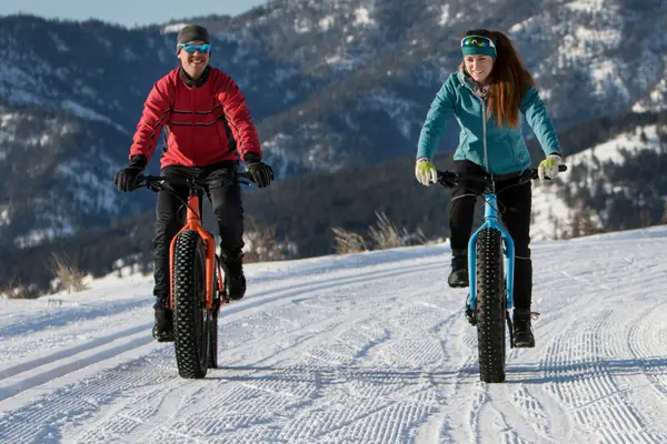 two cyclists on fat bikes in the snow
