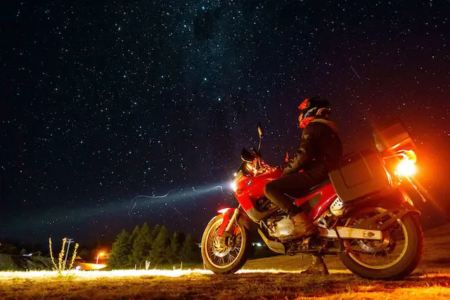 Man on touring BMW motorcycle at night