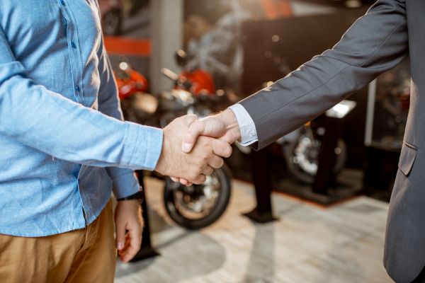 handshake deal at motorcycle dealership